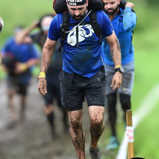 Rich Borgatti carrying a sandbag during a Spartan obstacle course race